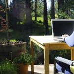 Woman working at computer in garden
